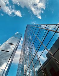 Low angle view of glass building against sky