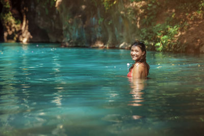 Young woman swimming in lake