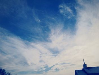 Low angle view of statue against blue sky