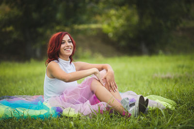 Smiling woman sitting on field