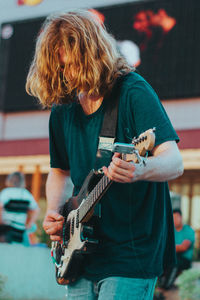 Full length of man playing guitar