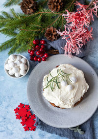 Christmas fruit cake or pudding with glaze, rosemary and cranberries. traditional winter bakery.