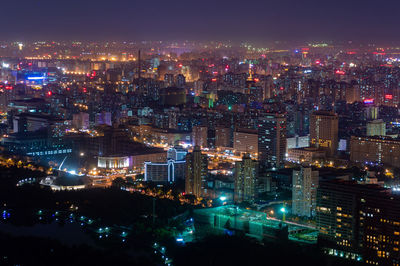 High angle view of illuminated city buildings at night