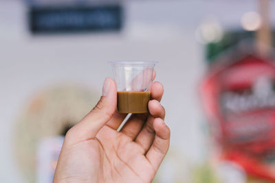 Close-up of hand holding drink