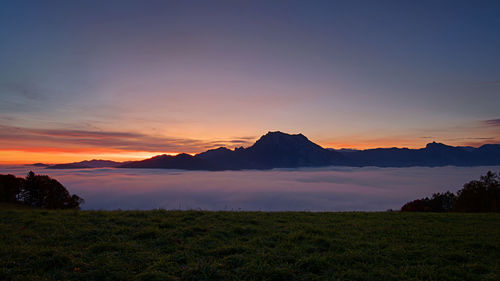 Scenic view of silhouette mountains against sky during sunset