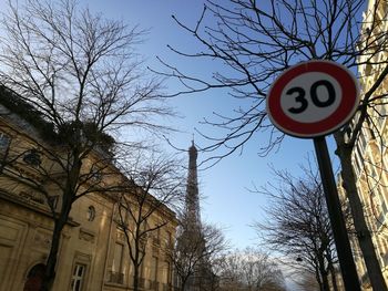 Low angle view of road sign against sky