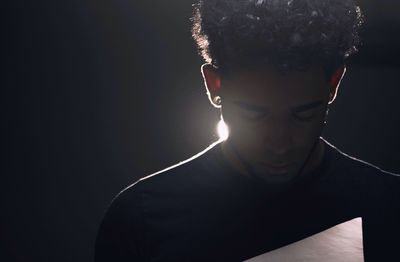 Close-up of man against black background