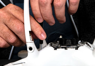 Midsection of man working on escalator