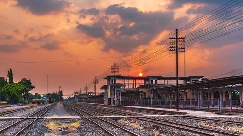 Railroad tracks against sky during sunset