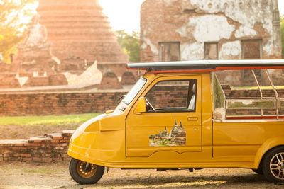 Yellow car parked outside building