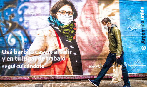 Man standing against graffiti wall