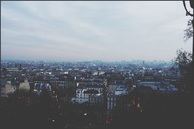 Cityscape against cloudy sky