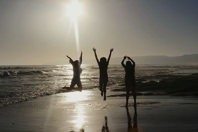 People on beach against sky