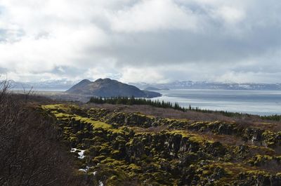 Scenic view of land and sea against sky