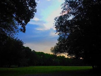 Scenic view of grassy field against cloudy sky