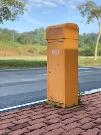 Close-up of yellow arrow symbol on roadside