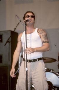 Young man with arms raised standing on stage