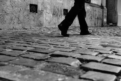 Low section of man walking on street