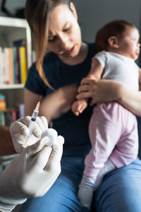 Side view of doctor examining patient at clinic