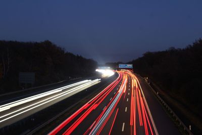 High angle view of light trails on road at night