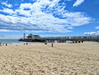 Scenic view of beach against cloudy sky