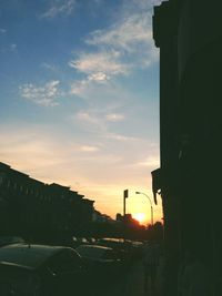 Vehicles on road at sunset