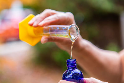 Close-up of woman hand holding bottle