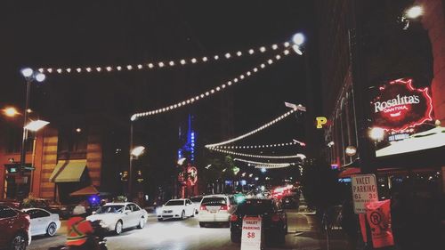 Illuminated city against sky at night