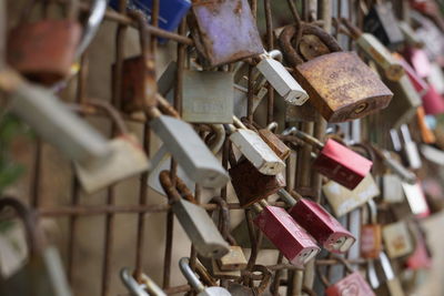 Close-up of padlocks hanging on railing