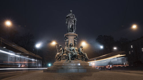 Longtime exposure from the king maximilian ii monument in munich surrounded by tramway by night