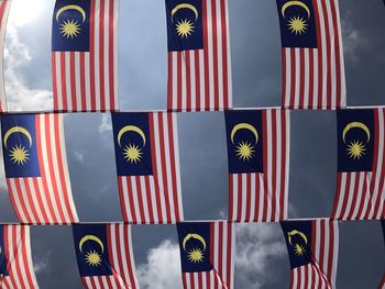 Multi colored flag flags against the sky