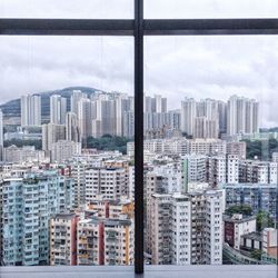 Cityscape against sky seen through window