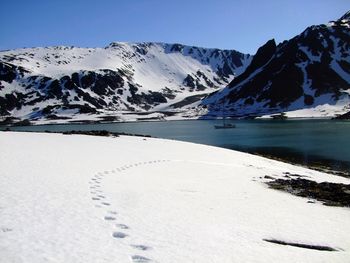 Scenic view of snow covered mountains against sky