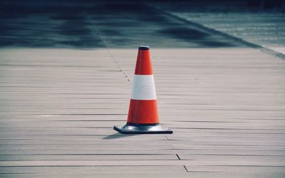 Traffic cone on wooden footpath