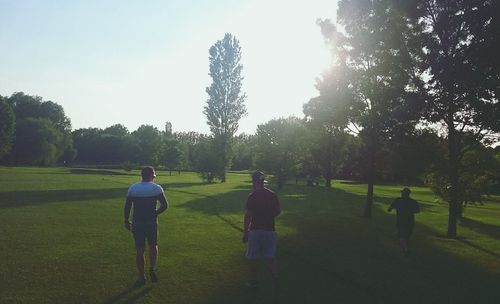 People walking on grassy field