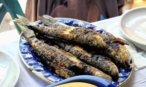 High angle view of grilled fish served in plate on table