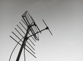 Low angle view of antennas against clear sky
