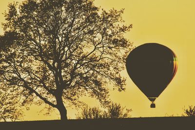 Silhouette hot air balloon against clear sky
