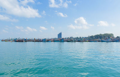 Scenic view of sea against sky in city