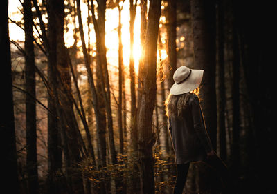 Rear view of woman walking in the forest