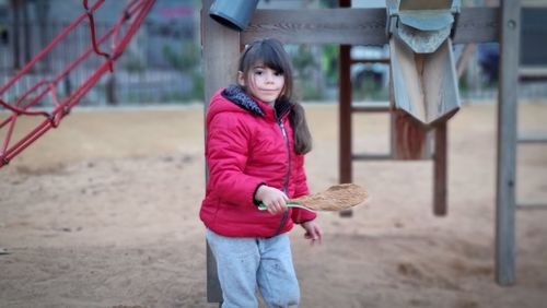 Full length of young woman standing on field