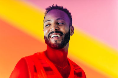 Portrait of young man against yellow background