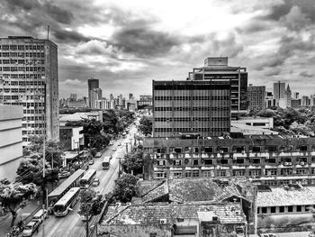 Buildings in city against cloudy sky