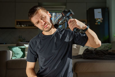 Portrait of young man exercising in gym