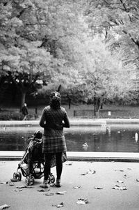 Rear view of women walking by lake