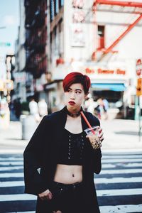 Young woman standing on city street