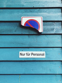 Close-up of text on wooden wall