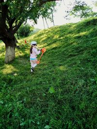 Full length of girl standing on grassy field