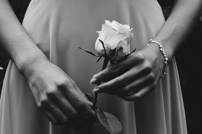 Close-up of hands holding rose bouquet