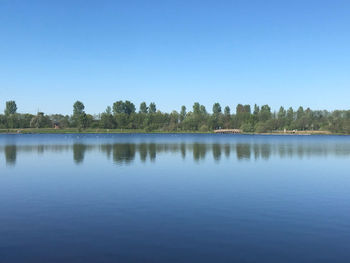 Scenic view of lake against clear blue sky